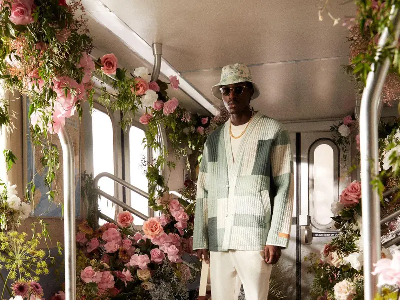 A KITH campaign photograph on a flower-filled subway car